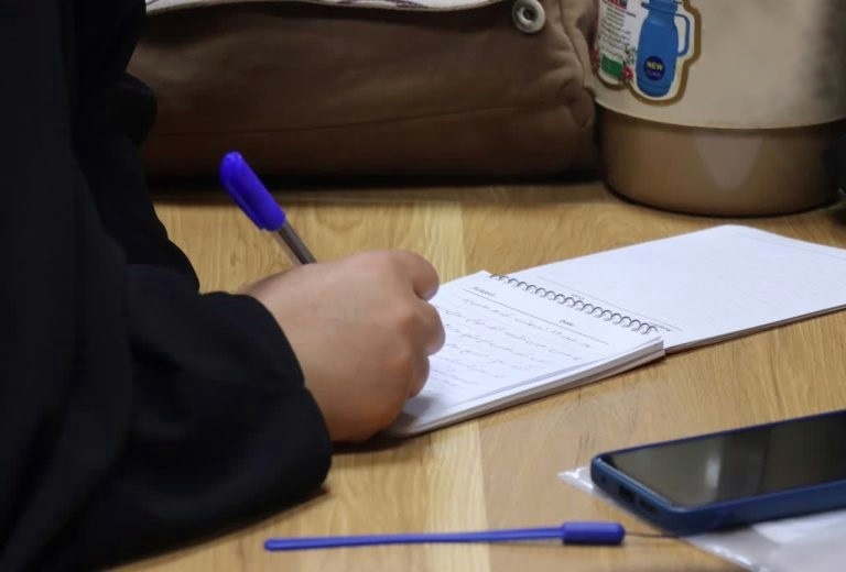 A person casts a line from the bow of a boat